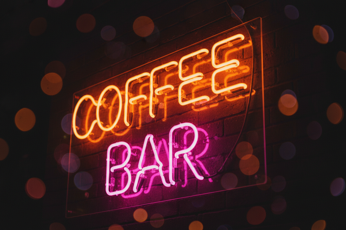 Bright neon sign reading 'Coffee BAR' against a brick background, enhancing your coffee corner décor with a vibrant and inviting atmosphere.